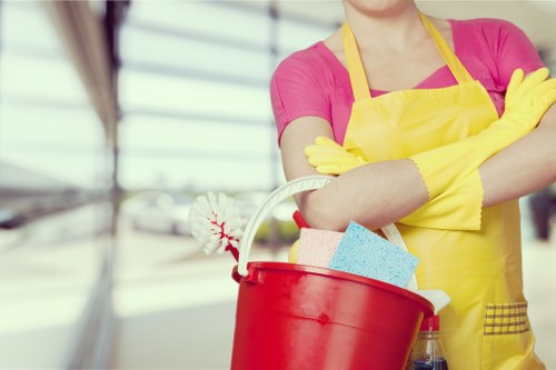 Professional cleaner preparing a commercial workspace in Acton